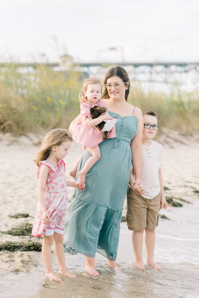 family playing in the water during sunset at Virginia Beach