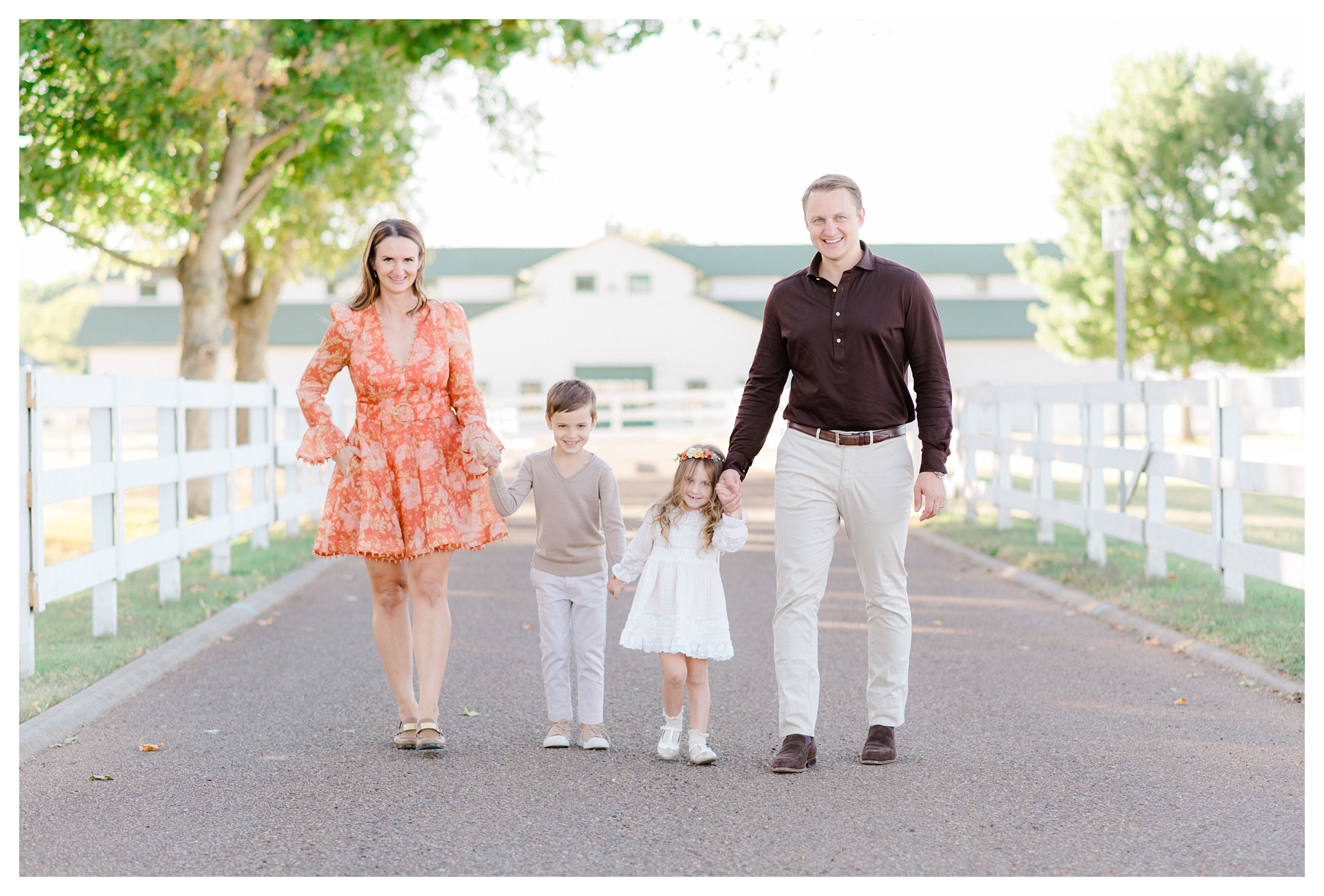 Family walking and holding hands during fall family photos in Williamsburg, Virginia