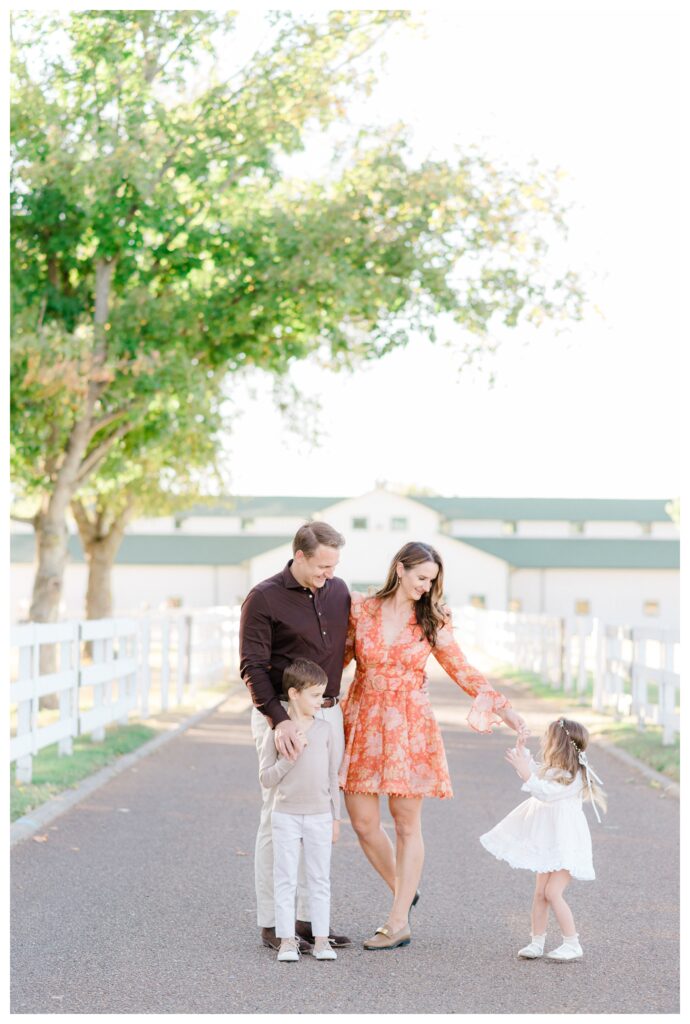 Family playing and dancing during fall family photos in Williamsburg, Virginia