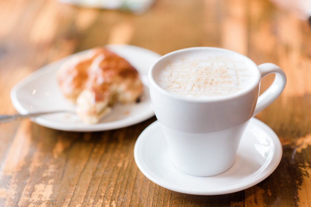 Fresh cappuccino and a butter croissant at Three Ships Coffee Roasters in Virginia Beach