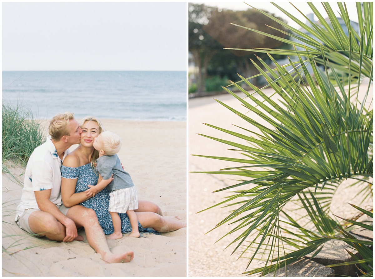 Family sitting and snuggling in the sand on the beach with palm trees lit up from the sunset glow
